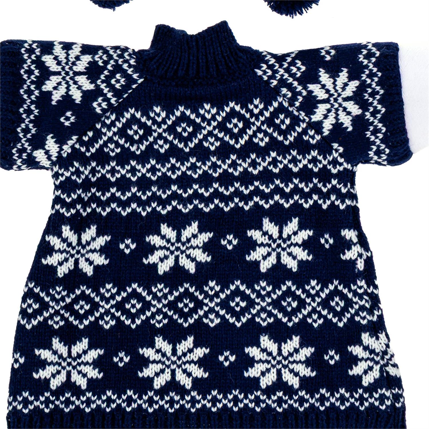 A navy blue and white knit sweater with a classic Fair Isle snowflake and geometric pattern, laid flat against a white background.