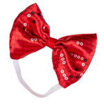 A red sequined bow headband with a white elastic band, featuring sequins in red, white, and black.