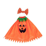 Giddy the Goose Pumpkin Poncho featuring an embroidered jack-o'-lantern face, leafy neckline, and matching polka-dot bow.