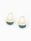 A pair of gold huggie hoop earrings with a semi-circular gold band and a polished blue stone drop at the bottom, shown on a clean white background.