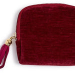 Three small zip-up pouches in red, green, and blue with tassels on a white background