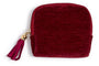 Three small zip-up pouches in red, green, and blue with tassels on a white background