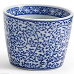 A small white ceramic cup or planter decorated with a classic blue floral and vine pattern, shown against a plain white background.