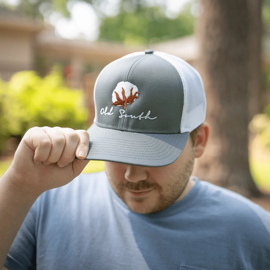 Old South Apparel Cotton Trucker Hat in Graphite and White featuring a structured crown, pre-curved visor, and adjustable snap-back closure.