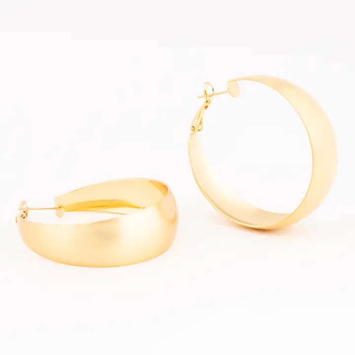A pair of large, polished gold hoop earrings shown on a clean white background.