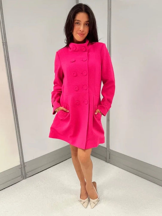 omen's hot pink honeycomb-textured statement coat with double-breasted covered buttons, high neckline, long sleeves, and front pockets.