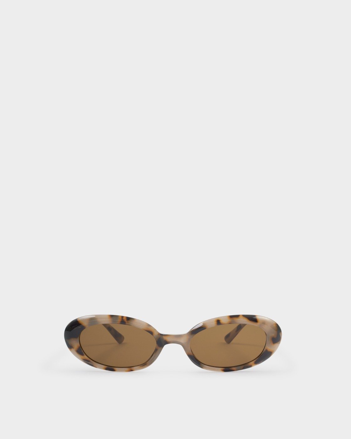 Oval sunglasses with a tortoiseshell pattern frame and brown lenses, displayed on a clean light gray background.