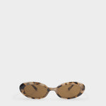 Oval sunglasses with a tortoiseshell pattern frame and brown lenses, displayed on a clean light gray background.