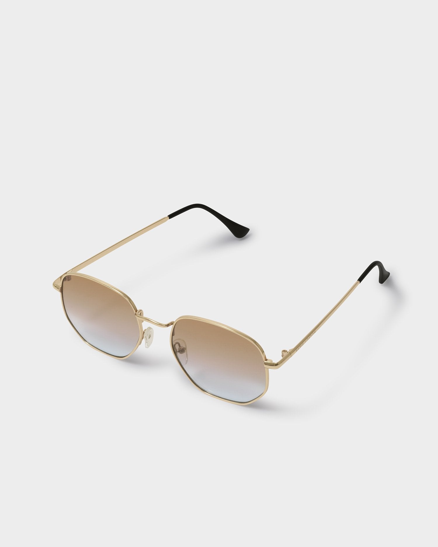 Gold-framed sunglasses with gradient lenses on a white background