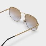 Gold-framed sunglasses with gradient lenses on a light gray background